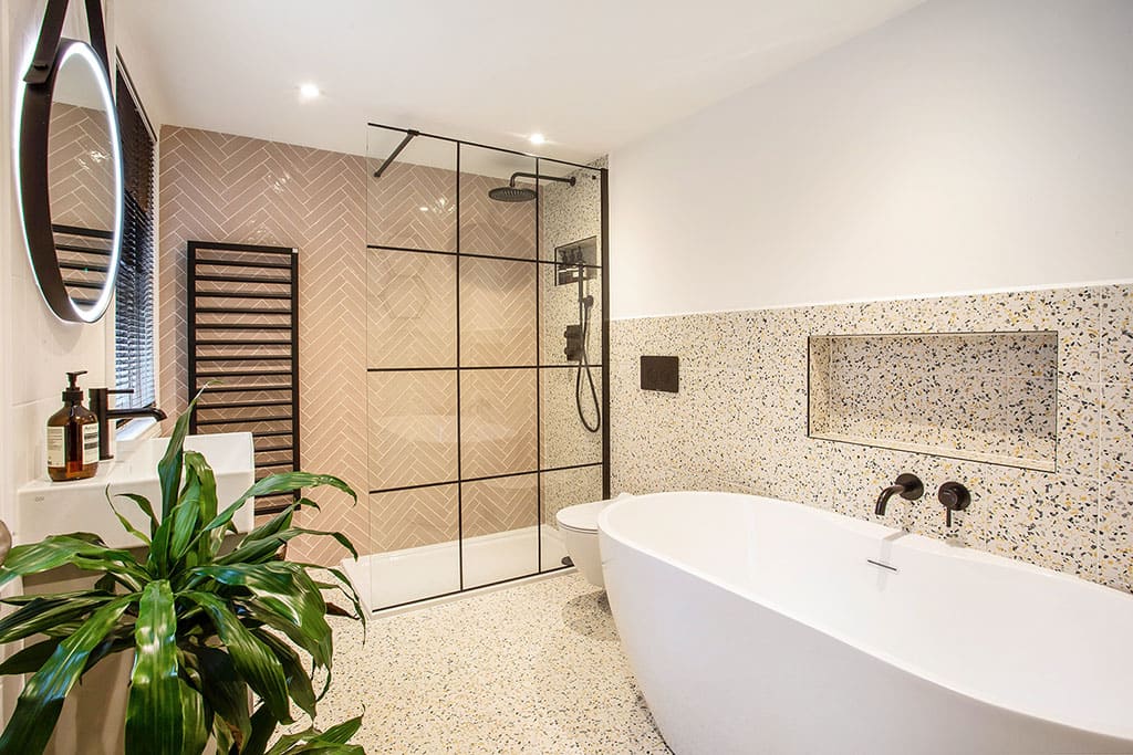 Modern bathroom with terrazzo tiles and freestanding bath