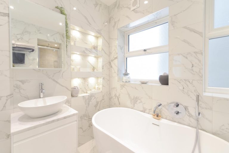 Luxurious bathroom with marble walls and a freestanding tub