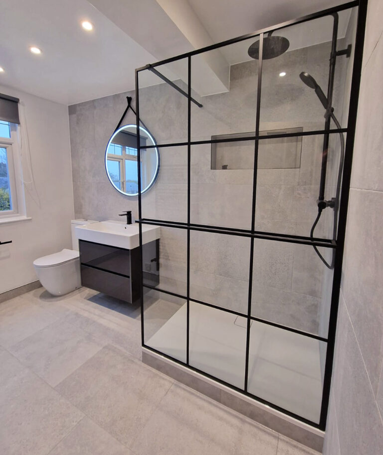 Modern bathroom with a black-framed shower and contemporary furniture