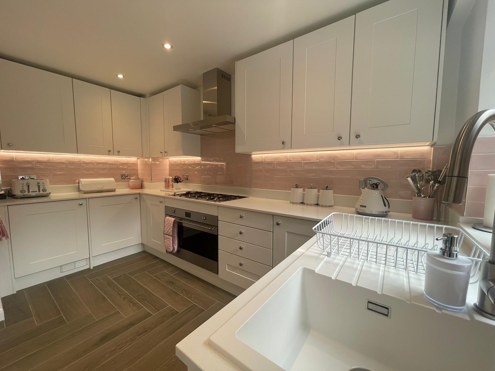 U-Shaped Shaker Kitchen Transformation with Pink Backsplash