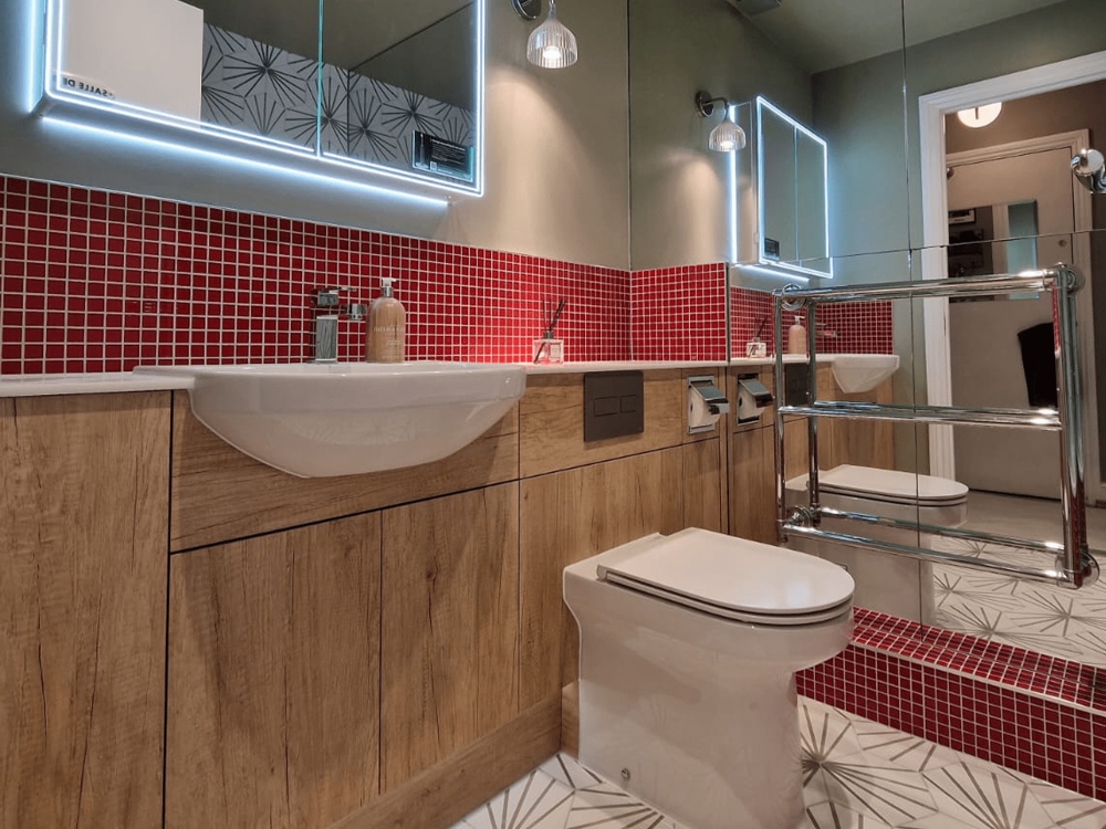 red_bathroom_tiles Bathroom sink with red tiles behind.