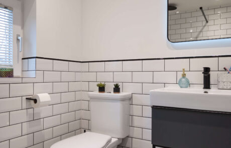bermondsey-second-bathroom-monochrome-floor-tiles-metro-wall-tiles.jpg Full room view of second bathroom with metro tiled walls, black accents, dark vanity, illuminated mirror and trailing plant at window