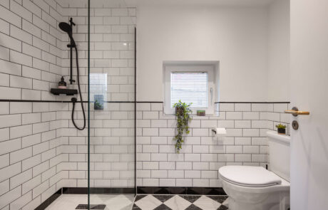 bermondsey-second-bathroom-walk-in-shower-metro-tiles-black-fittings.jpg Walk-in shower enclosure with white metro tiles, black shower fittings and black grout alongside monochrome diamond floor tiles