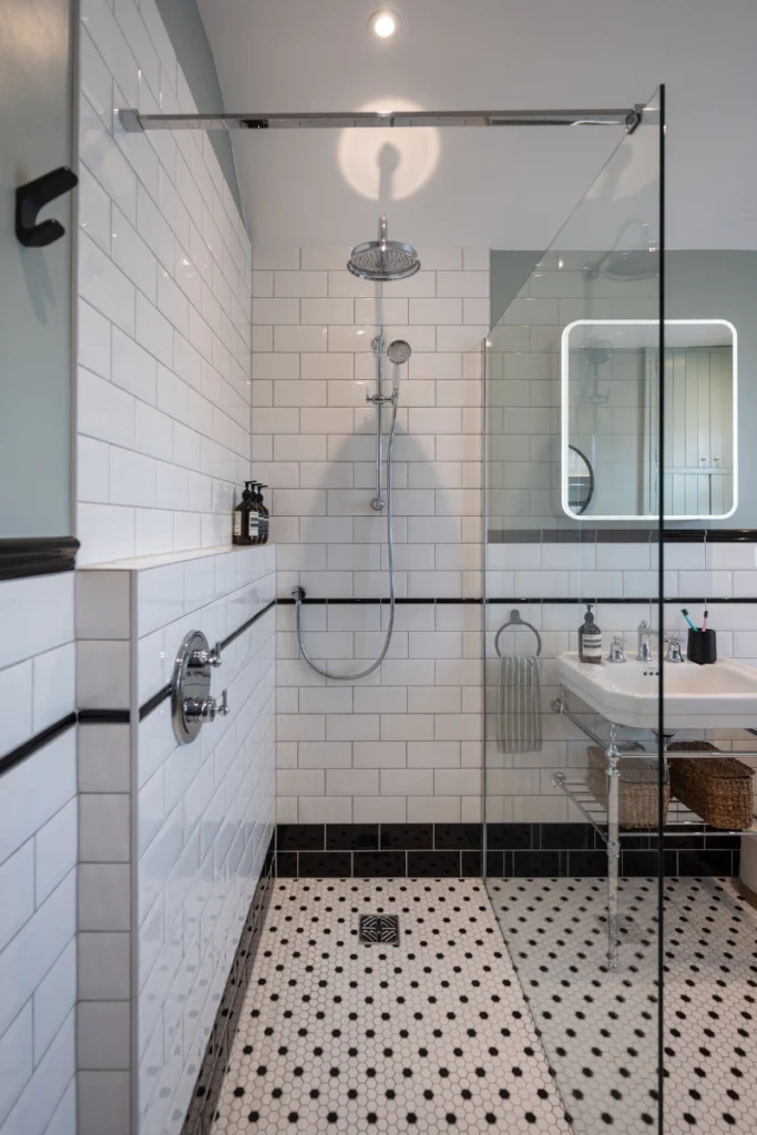 black-and-white-tiled-walk-in-shower-blackheath Vertical view of walk-in shower with black and white floor tiles in Victorian bathroom.