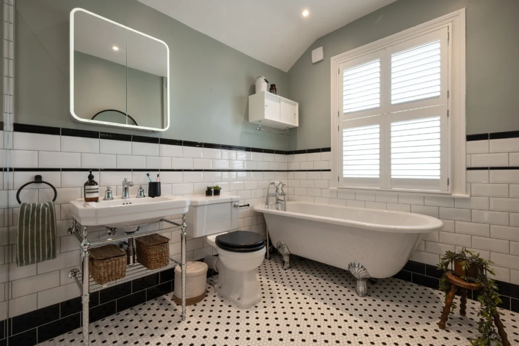 victorian-bathroom-basin-toilet-clawfoot-bath-blackheath Victorian-style bathroom in Blackheath with walk-in shower, basin and black-trimmed wall tiles.