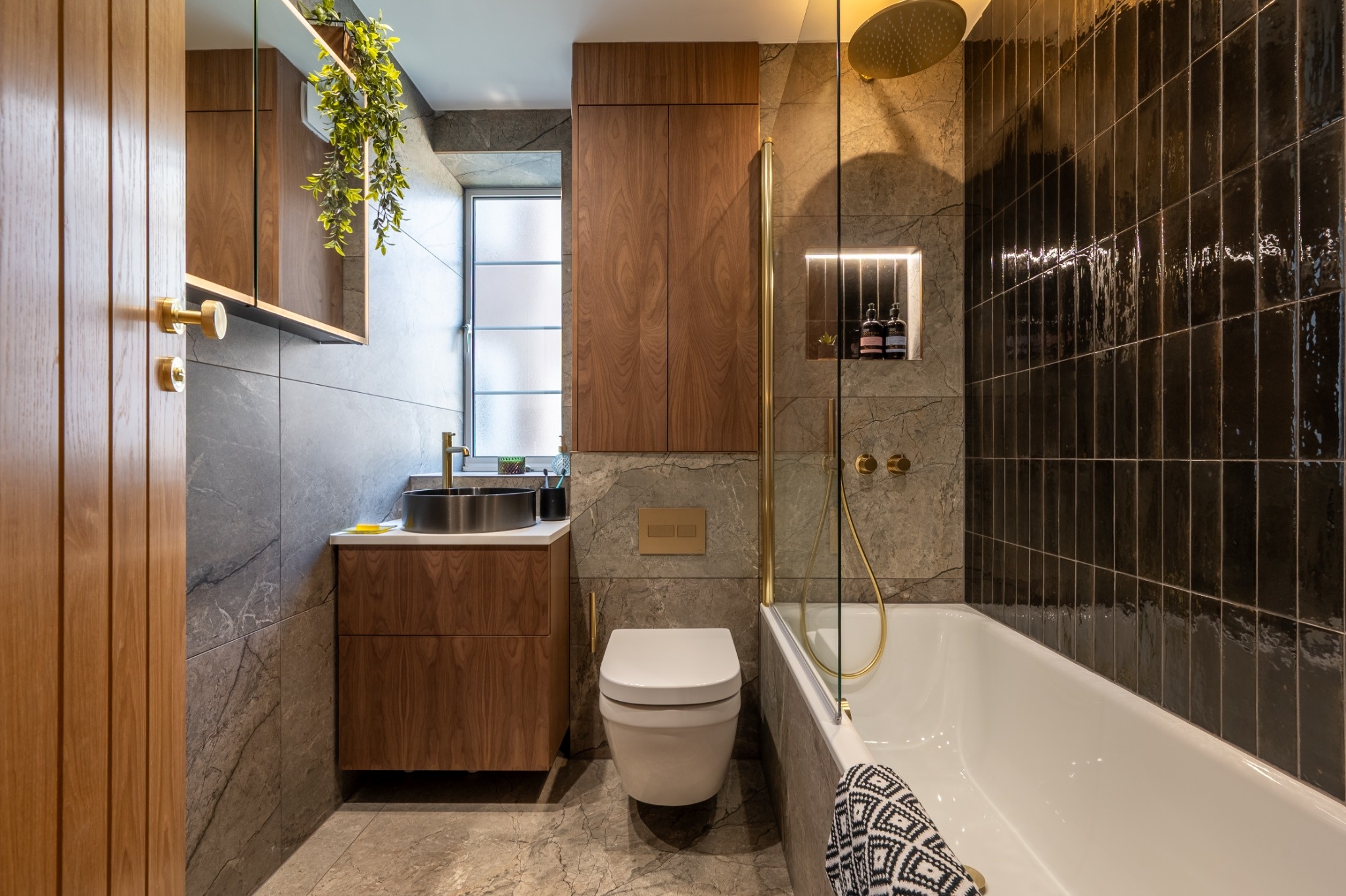 boutique-luxe-small-bathroom-walnut-cabinetry-brass-details.jpg